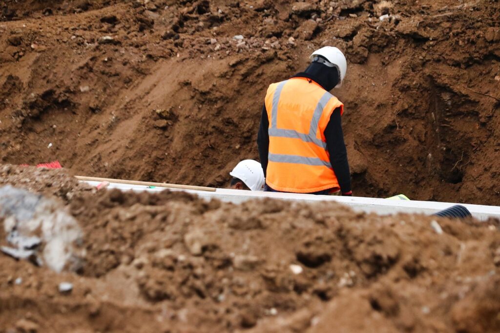 Stockbild inom byggprojekt: workers, construction, excavation